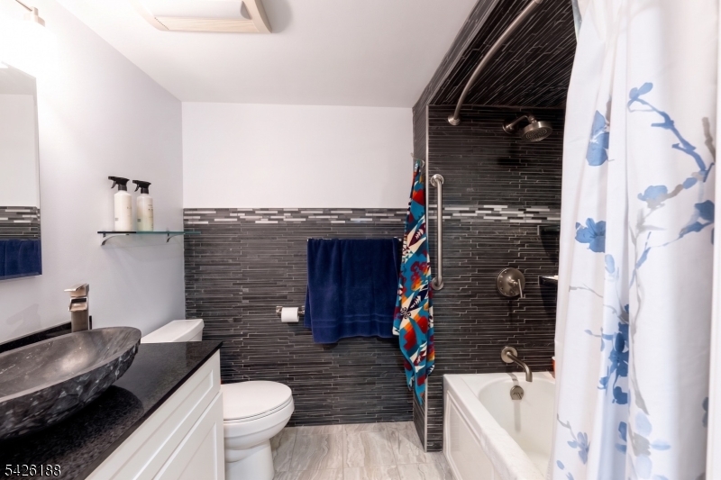 4 Millay Court Teaneck, NJ 07666 - Photo 26 of 32 a bathroom with a sink toilet and shower