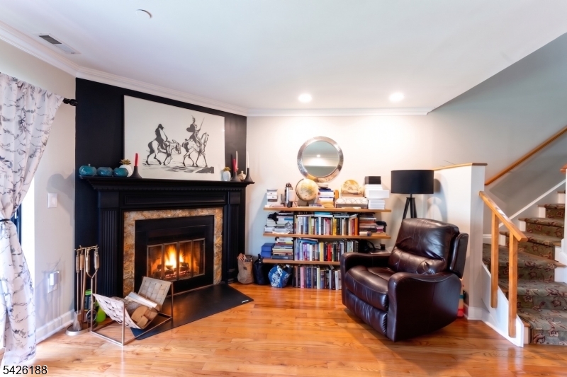 4 Millay Court Teaneck, NJ 07666 - Photo 3 of 32 a living room with furniture and a fireplace
