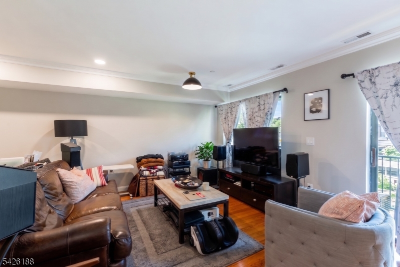 4 Millay Court Teaneck, NJ 07666 - Photo 32 of 32 a living room with furniture and a flat screen tv