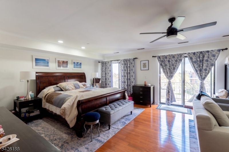 4 Millay Court Teaneck, NJ 07666 - Photo 4 of 32 a bed room with a bed and a couch