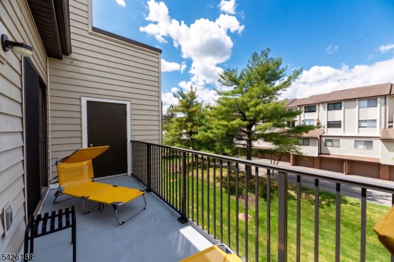 4 Millay Court Teaneck, NJ 07666 - Photo 6 of 32 a view of a chair and tables in the balcony