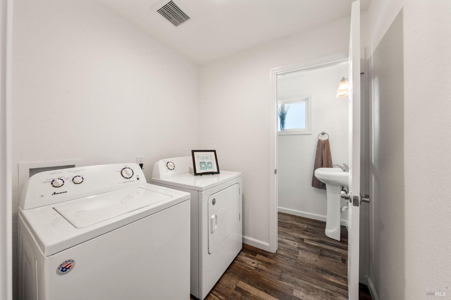543 St Francis Way Rio Vista, CA 94571 - Photo 26 of 44 laundry room with included washer and dryer; powder room is beyond