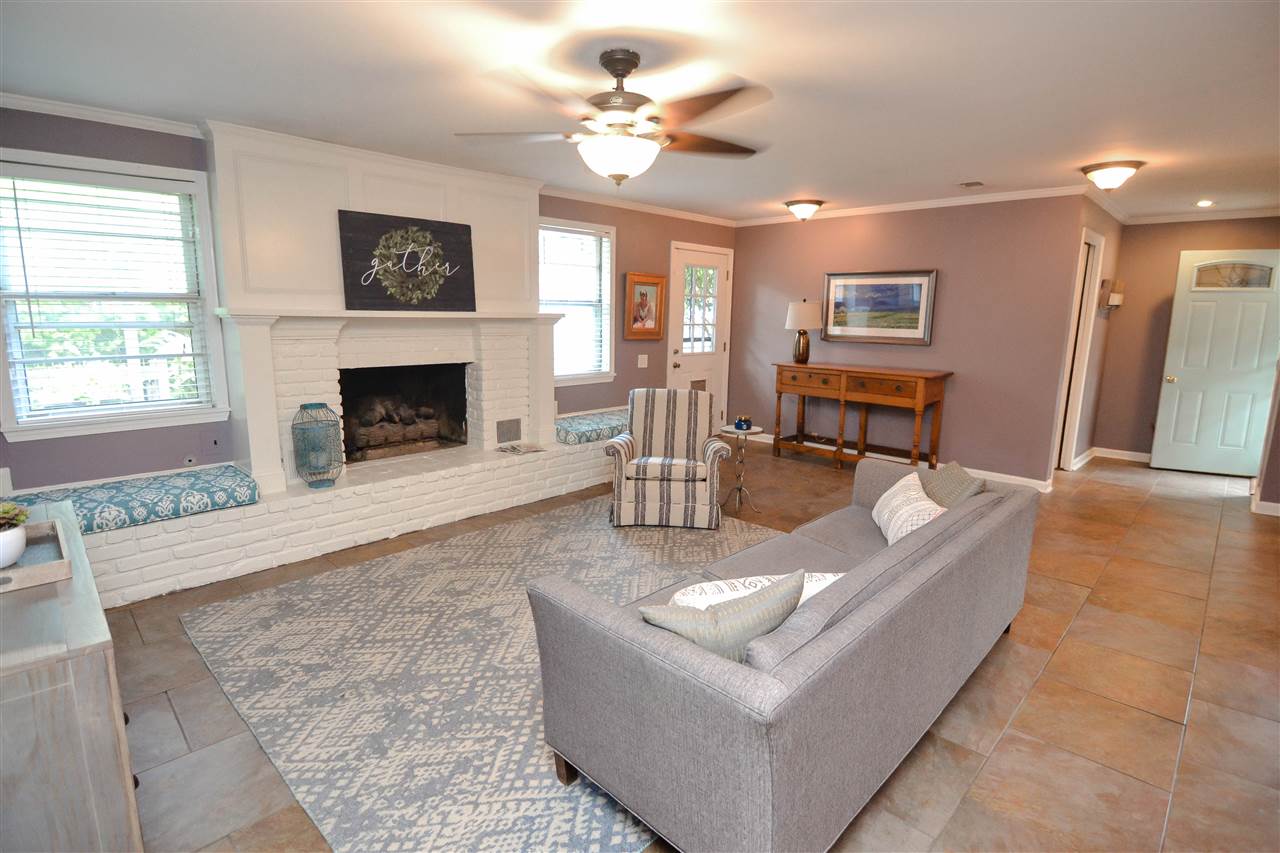 4856 Dee Road Memphis, TN 38117 - Photo 13 of 25 a living room with furniture a fireplace and a chandelier