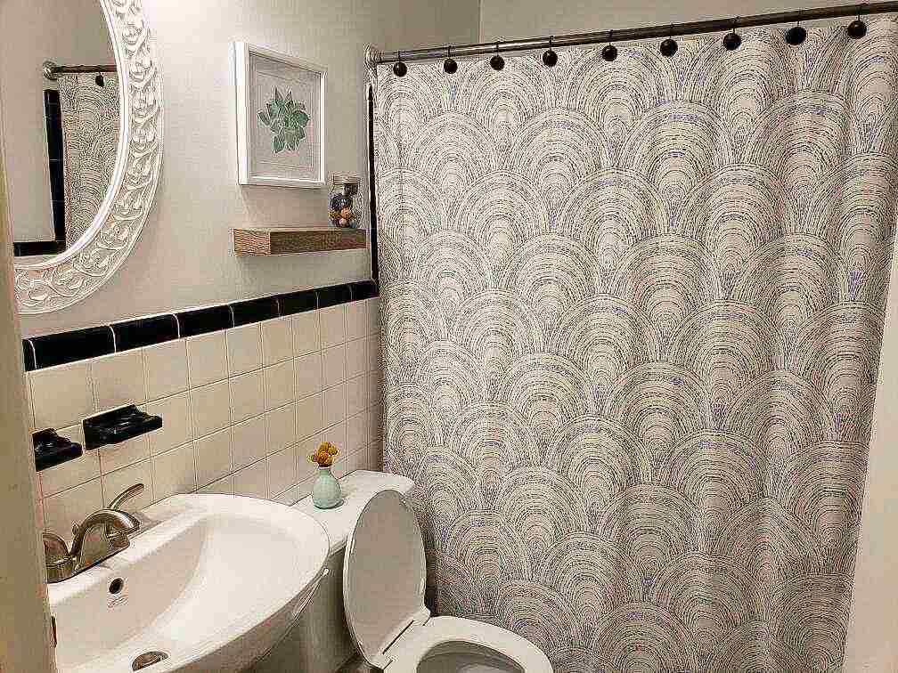 4856 Dee Road Memphis, TN 38117 - Photo 21 of 25 a bathroom with a sink a toilet and a mirror