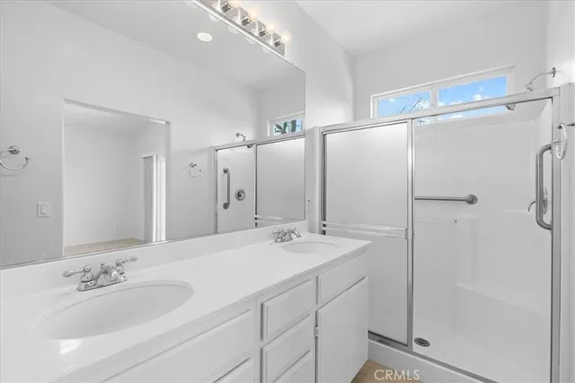 a bathroom with a double vanity sink mirror and double