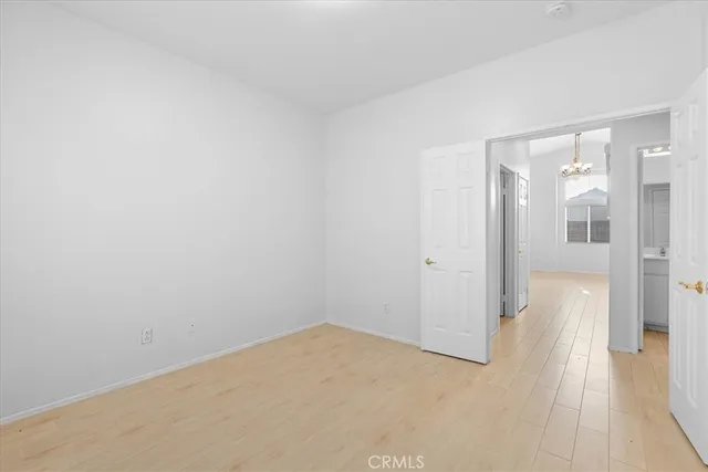 a view of a room with wooden floor and a bathroom