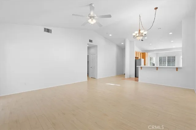 an empty room with a ceiling fan and a window
