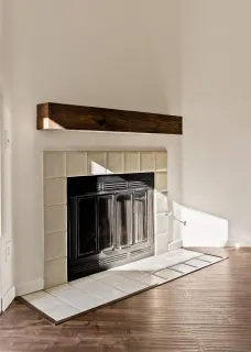 a view of a kitchen with a fridge and wooden floor
