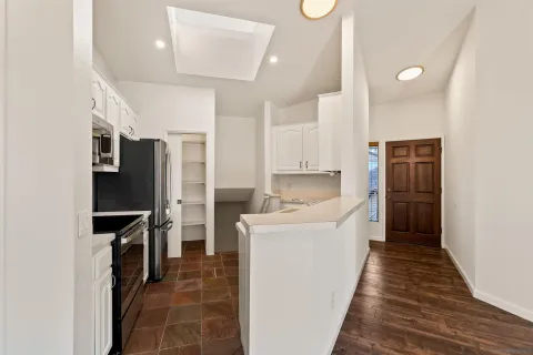 a kitchen with a sink stove and microwave