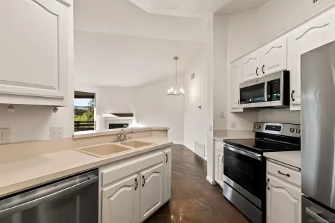 a kitchen with stainless steel appliances and refrigerator