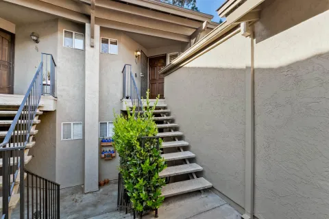 a view of a large building with trees in the background