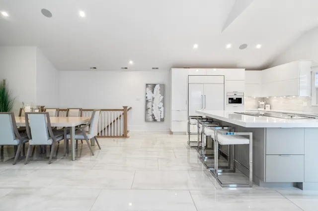 a large kitchen with a table and chairs