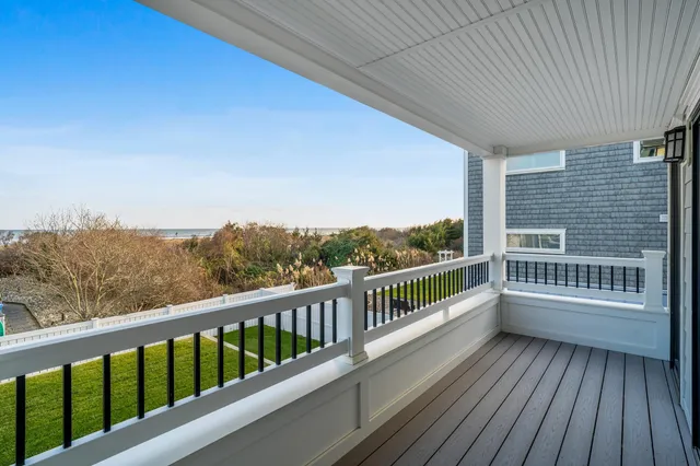 a view of a balcony with wooden floor