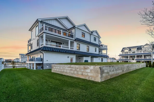 a view of a big building with a big yard and large trees