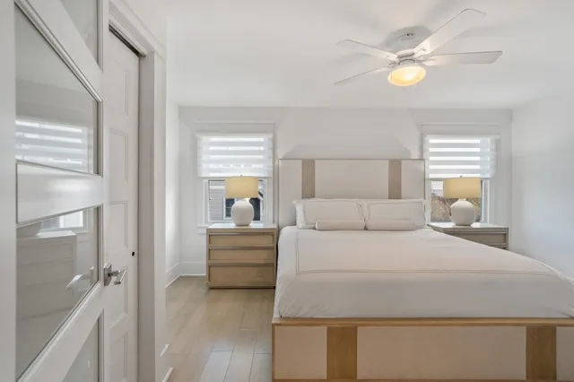 a bedroom with a bed and a chandelier