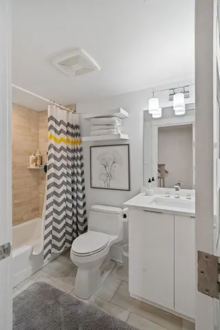a bathroom with a sink toilet and shower