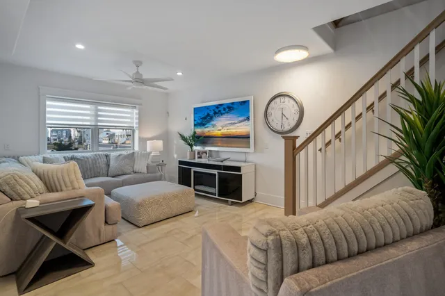 a living room with furniture a fireplace and a large window