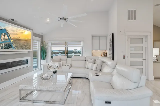 a living room with furniture large window and a fireplace