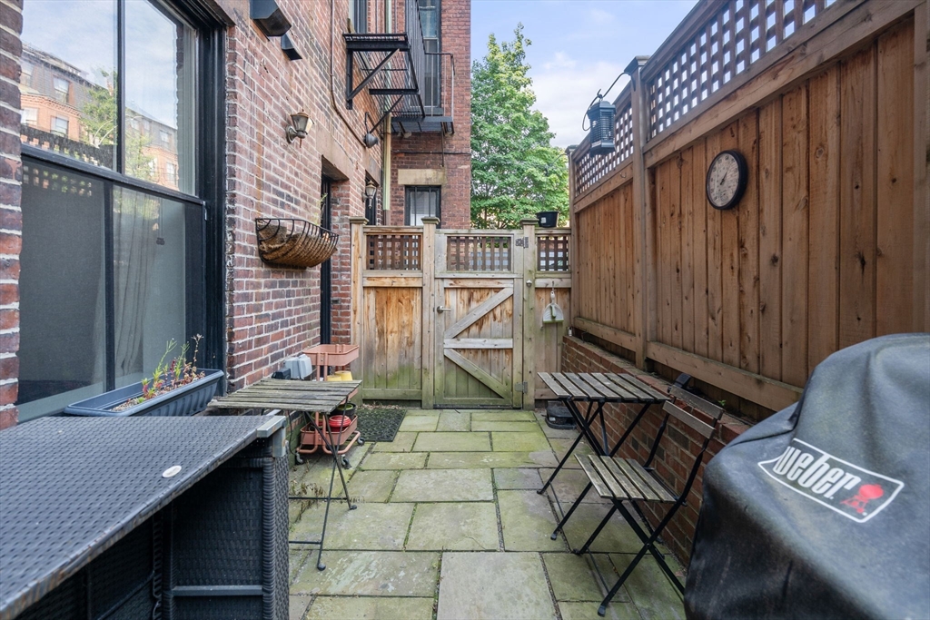 299 Marlborough Street, Unit 1 Boston, MA 02116 - Photo 13 of 15 a view of a patio with a table and chairs