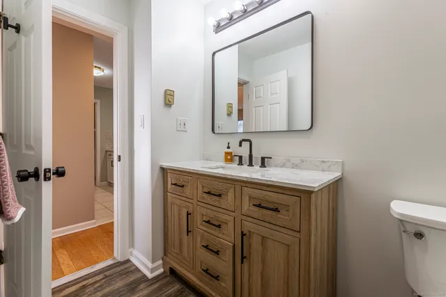a bathroom with a sink vanity and a mirror