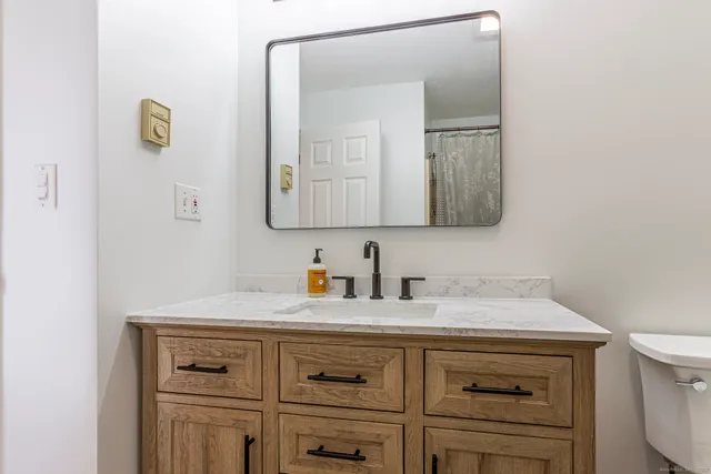 a bathroom with a sink a vanity and a mirror