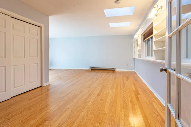 a view of a big room with wooden floor and staircase