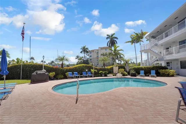 a swimming pool with outdoor seating yard and barbeque oven