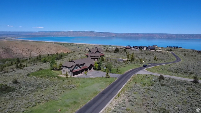 2 Summit, Unit 1 Fish Haven, ID 83287 - Photo 12 of 18 Property featuring a multi-level structure with stone and wood siding, a paved driveway, and an attached garage