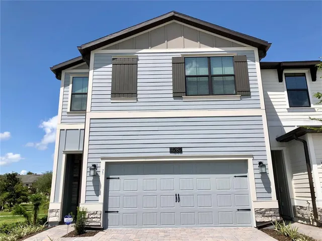 a front view of a house with garage