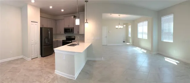 a view of a kitchen cabinets and a refrigerator