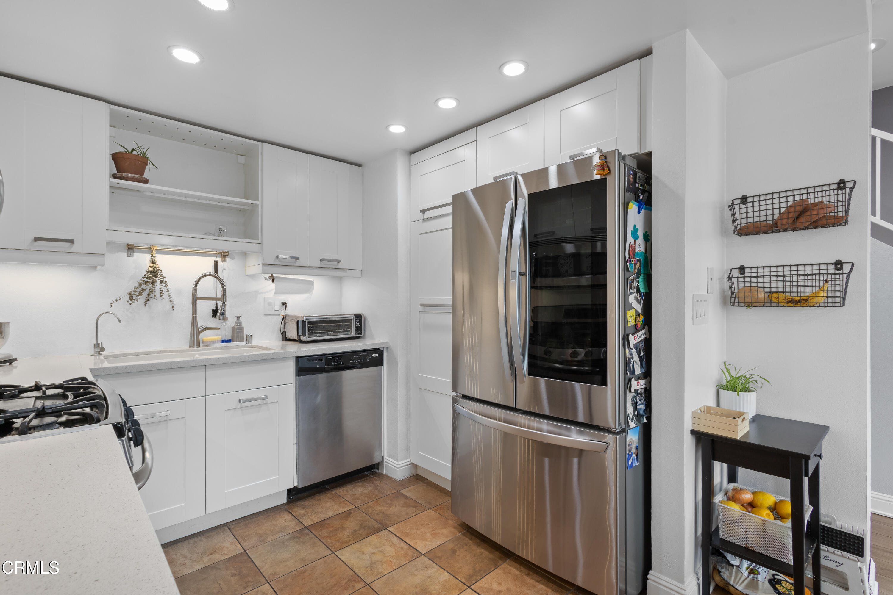 3235 Kelp Lane Oxnard, CA 93035 - Photo 6 of 22 a kitchen with stainless steel appliances granite countertop a refrigerator and a stove