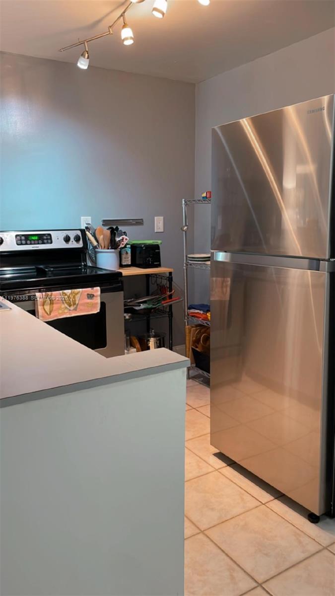 1673 Bay Road, Unit 303 Miami Beach, FL 33139 - Photo 2 of 10 a stove top oven sitting inside of a kitchen