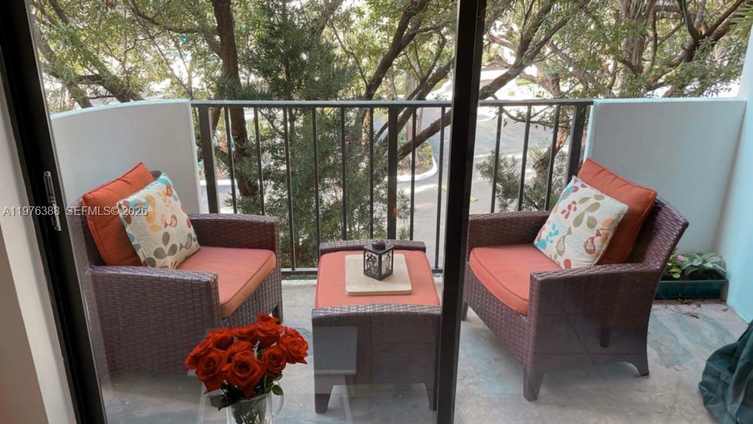 1673 Bay Road, Unit 303 Miami Beach, FL 33139 - Photo 6 of 10 a outdoor living space with furniture and garden view