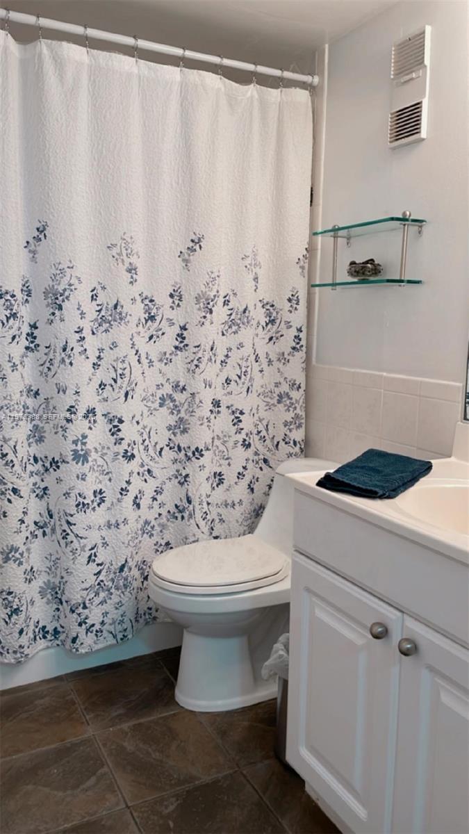 1673 Bay Road, Unit 303 Miami Beach, FL 33139 - Photo 8 of 10 a bathroom with a toilet and a shower