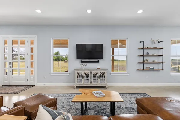 a living room with fireplace furniture and a flat screen tv