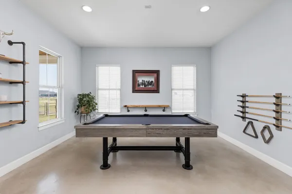 a living room with furniture a flat screen tv and a window