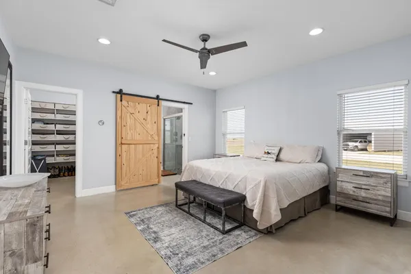 a room with furniture pool table and windows
