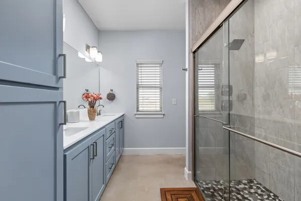 a bedroom with a bed a flat screen tv and a couch