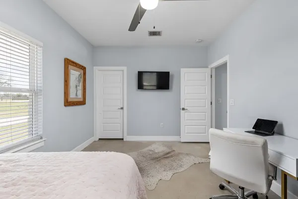 a bedroom with a bed and a desk