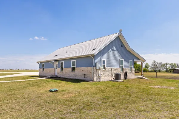 a swimming pool with outdoor seating and yard