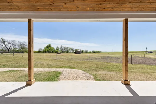 a kitchen with cabinets a sink stainless steel appliances and dining table