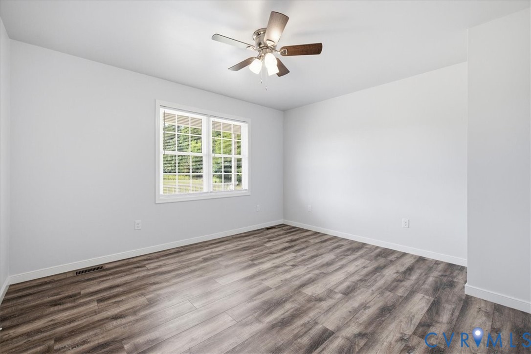6019 Otterdam Road Waverly, VA 23890 - Photo 23 of 26 Wood-finish flooring, white walls, and a ceiling f