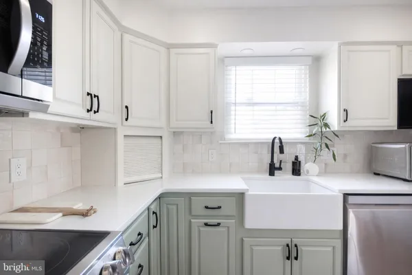 a kitchen with a sink cabinets and window