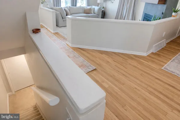 a view of a living room with furniture and wooden floor