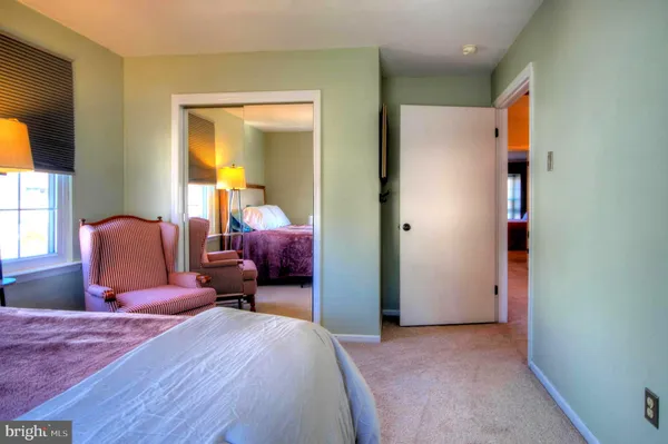 a bedroom with furniture and a window