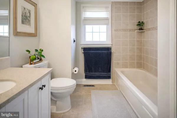 a bathroom with a sink a toilet and bathtub