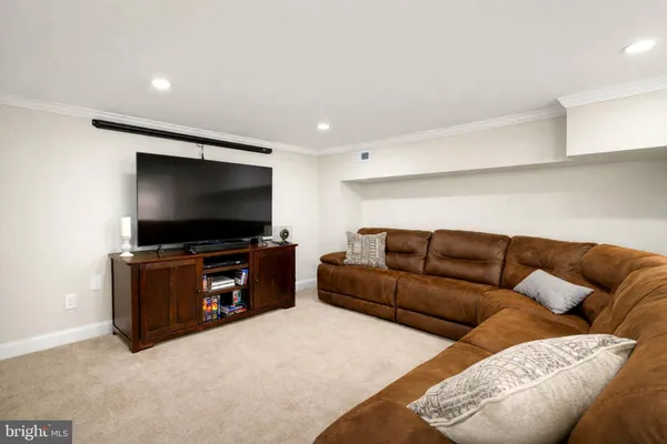 a bedroom with furniture and a flat screen tv