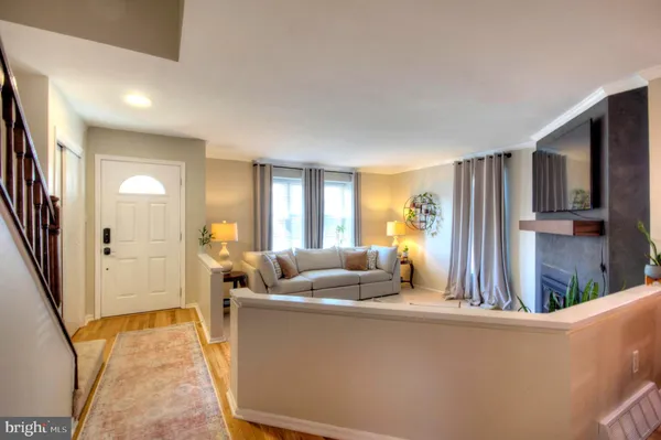 a living room with furniture fireplace and a large window