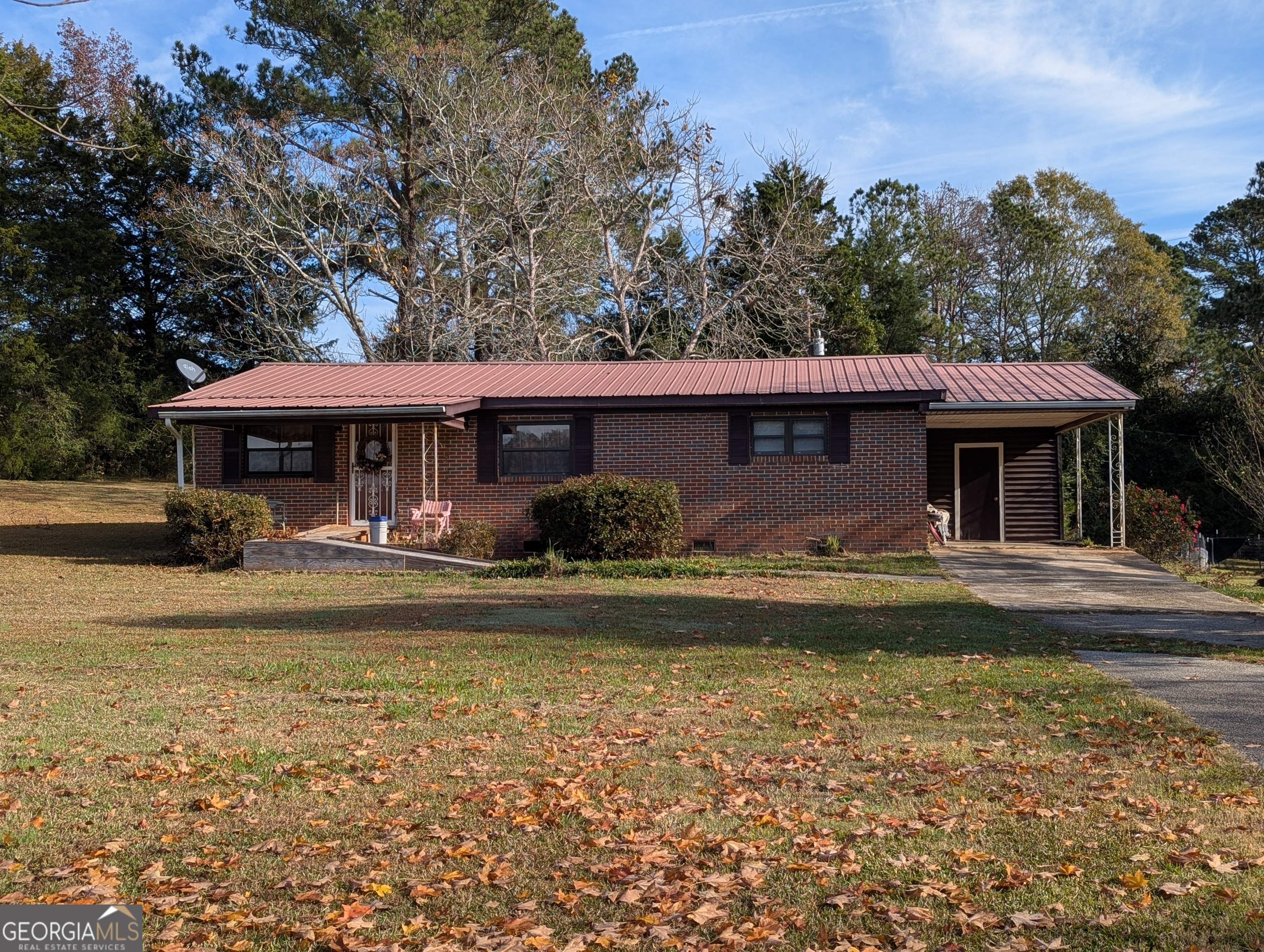 1014 Five Points Road Barnesville, GA 30204 - Photo 1 of 1 a view of a swimming pool with lawn chairs under an umbrella