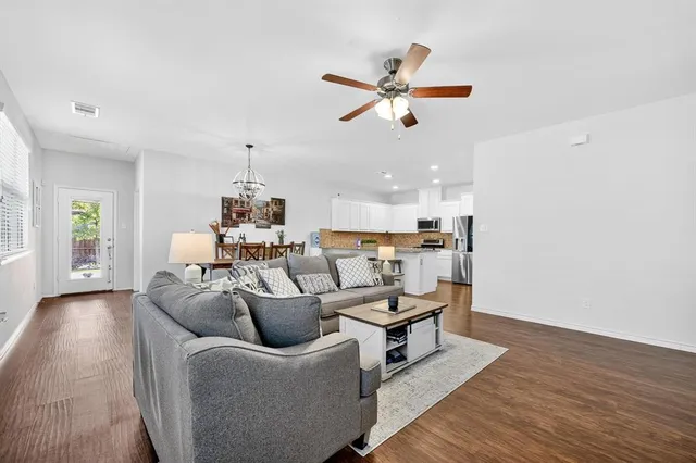 a living room with furniture and a wooden floor